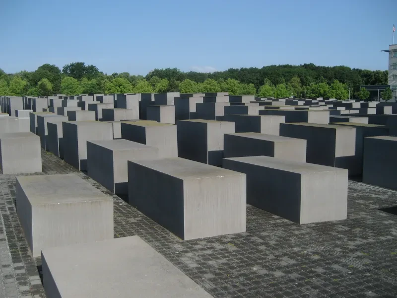 Das Stelenfeld, im Hintergrund sind grüne Bäume zu sehen.