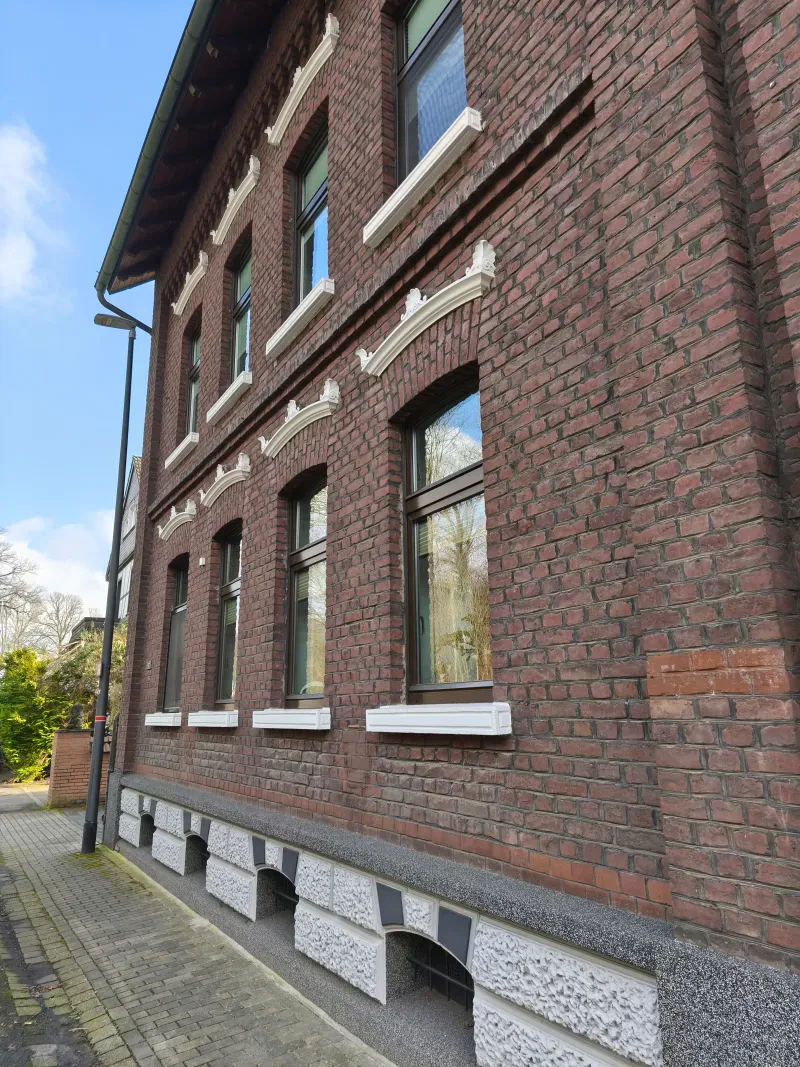 Ein zweistöckiges rotes Ziegelhaus.