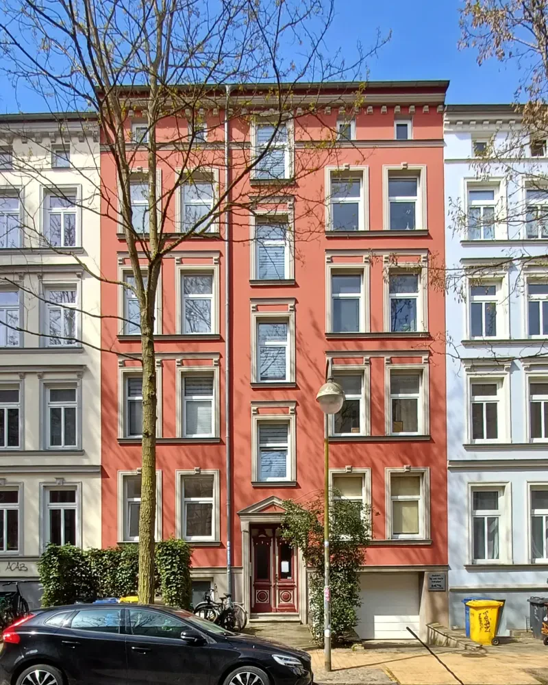 Ein rotes mehrstöckiges Stadthaus.