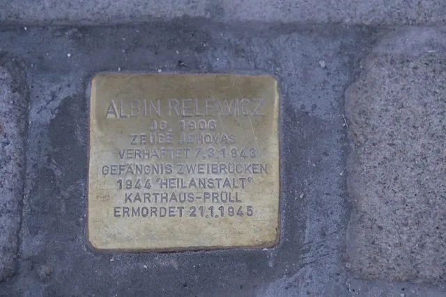 Ein Stolperstein mit der Aufschrift: "Albin Relewicz / Jg. 1906 / Zeuge Jehovas / Verhaftet 7.3.1943 / Gefängnis Zweibrücken / 1944 'Heilanstalt' Karthaus-Prüll / ermordet 21.1.1945"