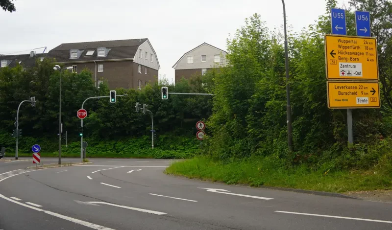Die neu gestaltete Burger Straße endet in einer Einmündung zur Bundesstraße 51, an der es rechts nach Burscheid und links nach Bergisch Born geht.